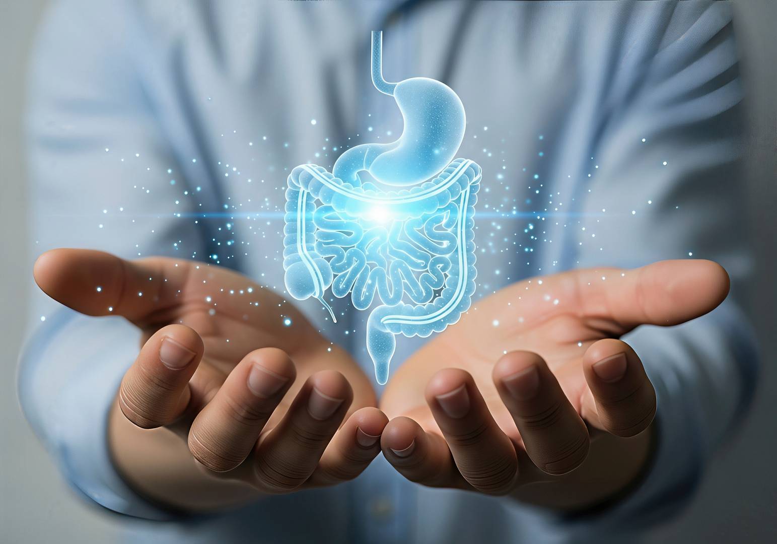 Obraz przedstawia osobę trzymającą w dłoniach holograficzny model układu pokarmowego, symbolizujący zdrowie jelit i trawienie.